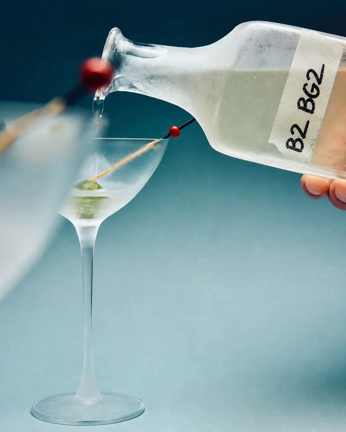 A cocktail being finished by hand